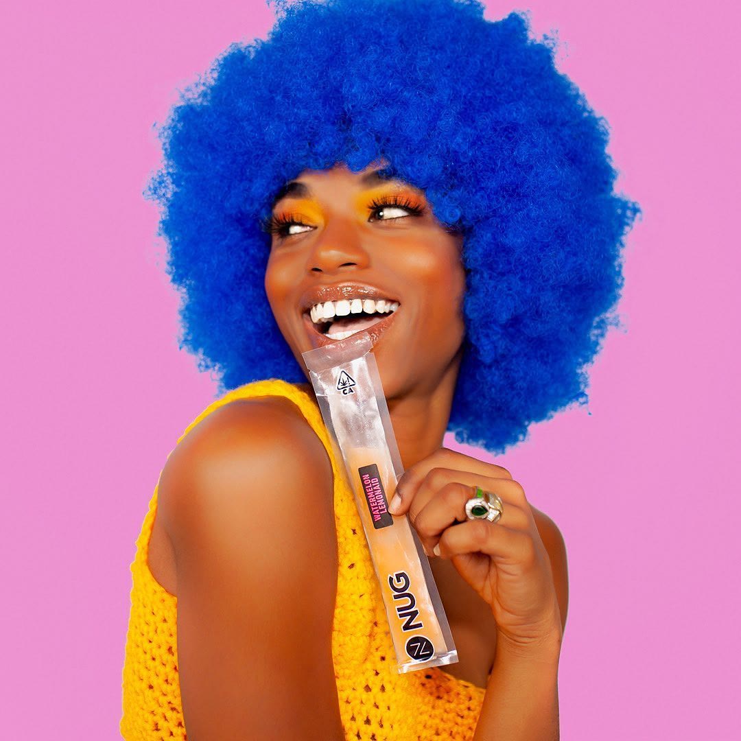 Colorful product campaign portrait against a pink background